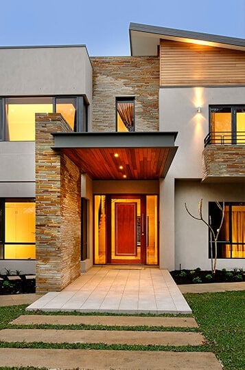 Entrance view of a luxury home that represents one of the testimonials.